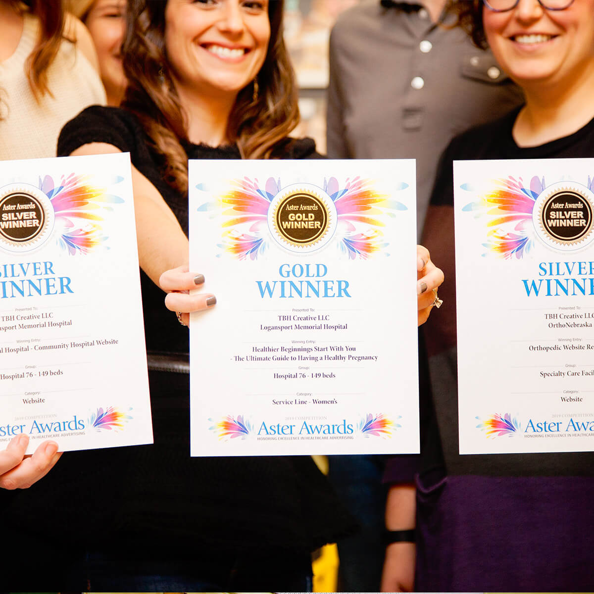 Team holding up Aster Awards won by TBH Creative